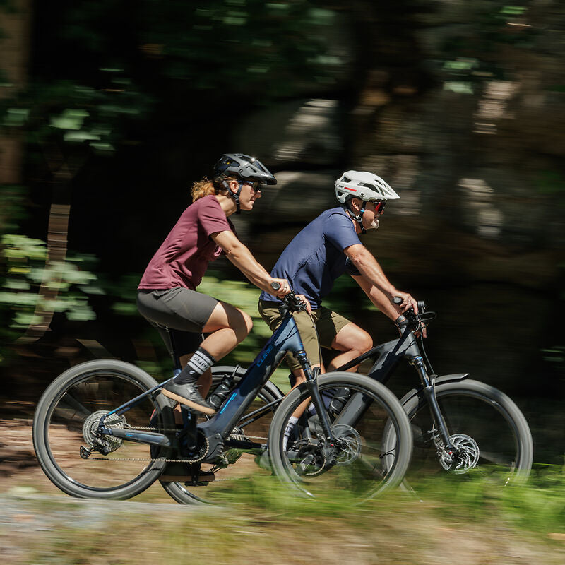 Electric mountain bikes riding on forest trail for outdoor cycling adventure and performance biking