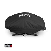 Black Weber grill cover on a white background