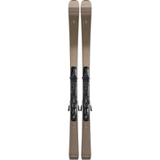 A pair of ski boots mounted on skis, shown vertically against a solid white background. The boots are dark gray/black with metallic silver buckles, and the skis are a warm taupe-brown color with a small white logo near the top.