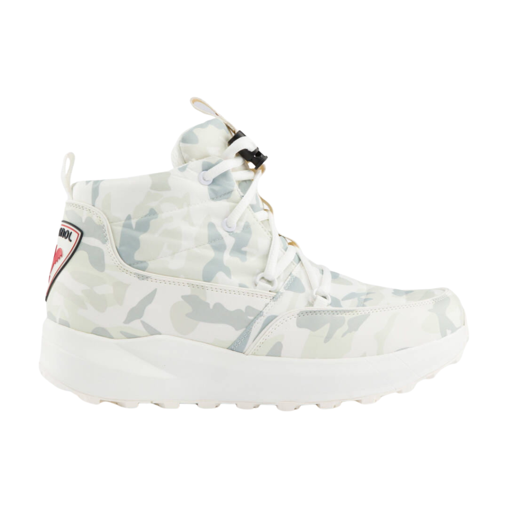 A high-top sneaker in a light camouflage pattern featuring white, gray, and pale green tones, with white laces, a thick white sole, and a small red and black logo patch on the side heel.