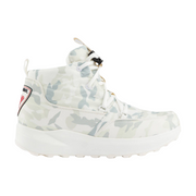 A high-top sneaker in a light camouflage pattern featuring white, gray, and pale green tones, with white laces, a thick white sole, and a small red and black logo patch on the side heel.