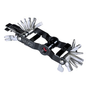 A black and silver multi-tool bicycle chainstay tool with various flathead screwdriver bits extended, shown on a plain white background.
