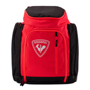 Red and black backpack with a visible brand logo on a light gray background