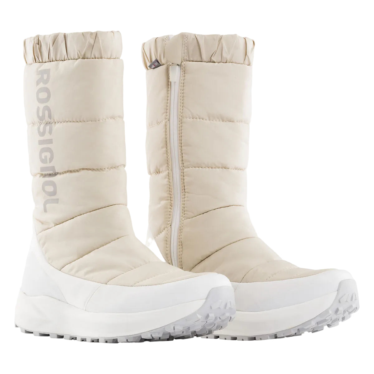 Pair of beige winter boots with white soles on a light gray background