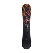 A snowboard shown vertically against a light gray gradient background. The snowboard features a black base with a vibrant graphic design resembling glowing orange and yellow cracks or veins on the upper half, transitioning to a dark, textured lower half with a small teal logo near the bottom.