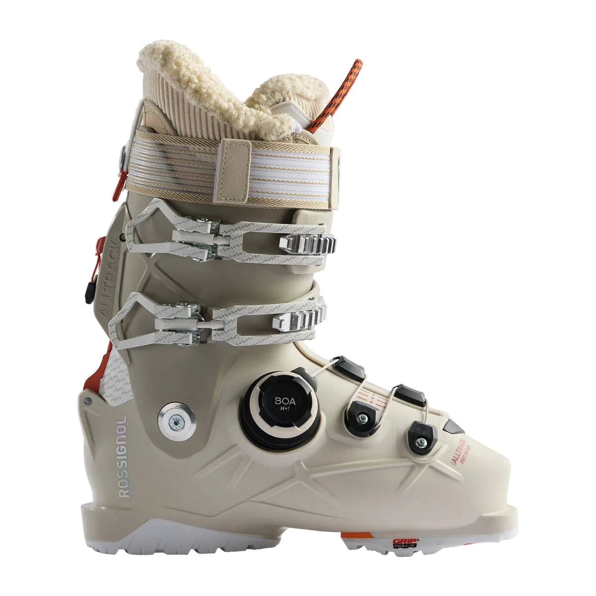 A single ski boot in light beige with white and silver buckles, a black dial closure, and a cream-colored fleece lining, shown against a neutral light gray background.