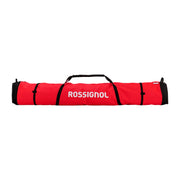 A red and black Rossignol sports bag with white brand lettering, shown horizontally against a light gray gradient background.