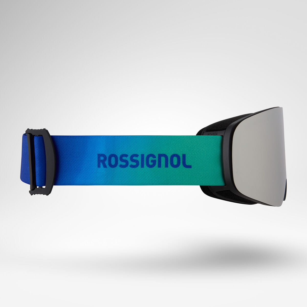 Rossignol ski goggles with a vibrant blue and green gradient strap, a black buckle, and a silver mirrored lens, shown against a light gray gradient background.