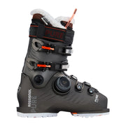 A Rossignol Pure ski boot in dark gray and black with white fur lining, orange accents, and a BOA dial closure system, shown against a light gray studio background.