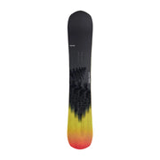 A snowboard shown vertically against a light gray gradient background. The board features a black top section with a subtle forest tree graphic, transitioning into a bright yellow and orange gradient toward the base.
