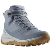 A Salomon mid-cut hiking boot in a muted slate blue-gray color, featuring a white midsole and a tan/gum outsole, shown against a plain white background.