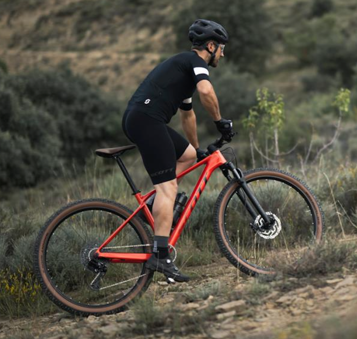 Man riding mountain bike on trail with cycling helmet and gear outdoor MTB biking